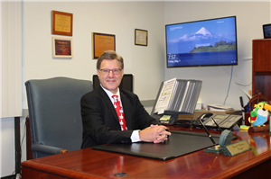 Photo of Principal Schneider at his desk.
